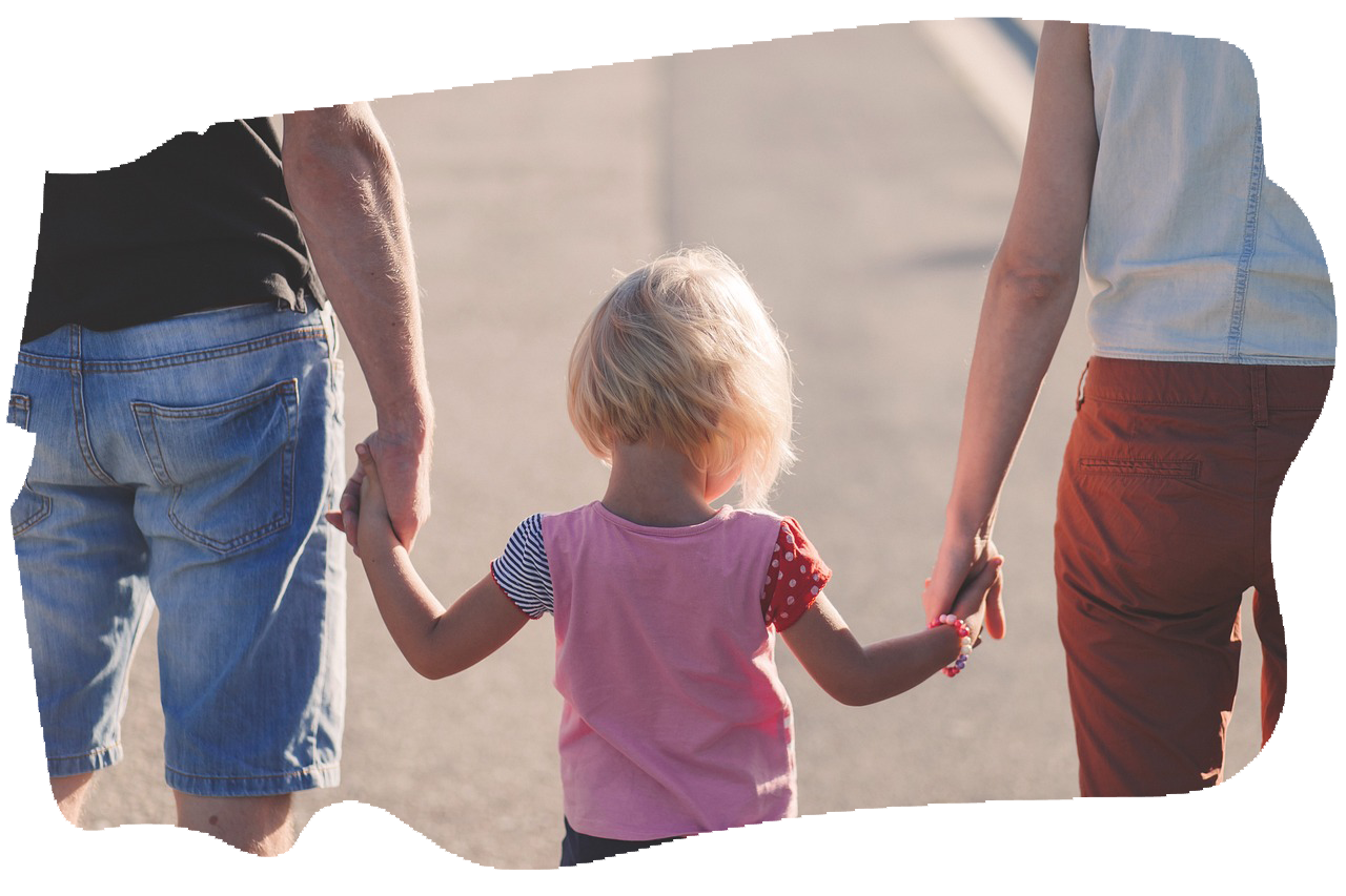 adopted child holding hands with adoptive parents